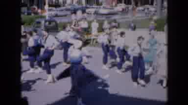 Iowa USA (1959): People Dancing In Unison On Street As Crowd Watches