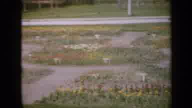 Iowa USA (1959): Girl Wearing Blue Dress Walks On Sidewalk On A Bright Sunny Day