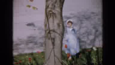 Iowa USA (1959): Girl Walking Through Garden With Well-Kept Grass And Flowers In