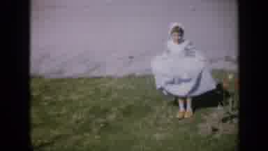 Iowa USA (1959): Young Girl Dressed In A Long Blue Dress And A Flower Garden