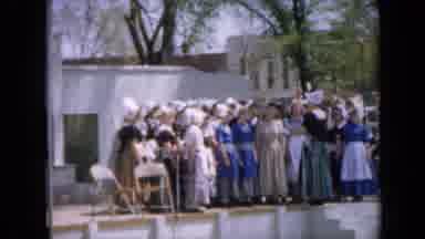 Iowa USA (1959): A Choir Of Young Girls And Their Director Are Dressed As Pilgrims
