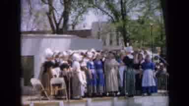Iowa USA (1959): Young Girls In Traditional Dress Raise Their Arms Or Stand In A