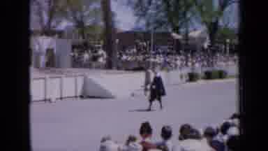 Iowa USA (1959): Royal Guard Paces In Front Of Crowd And White Steps On A Sunny
