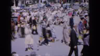 Iowa USA (1959): Many People Walking In The Same Direction As Spectators Watch