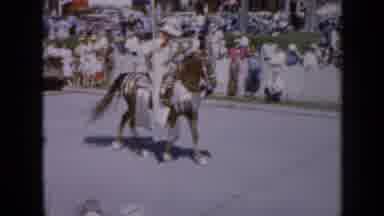 Iowa USA (1959): Three People Riding Horses Holding 3 Different Flags Parading