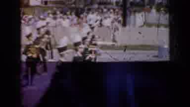 Iowa USA (1959): Marching Band Marching Down A Street Then Kids Holding Hands With