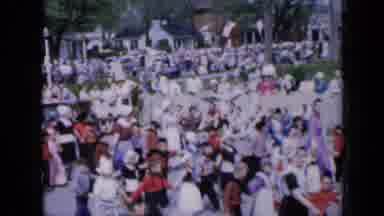Iowa USA (1959): Crowd Watches At Parade Marches Through The Streets Of A Small