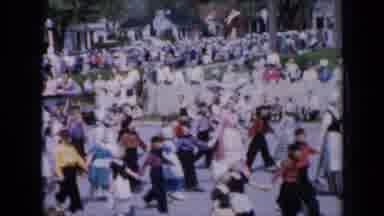 Iowa USA (1959): A Large Crowd Of Teenagers Parade Down The Road Holding Hands