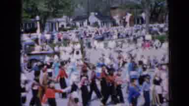 Iowa USA (1959): Group Of Children Marching Down A Street Together In A Parade