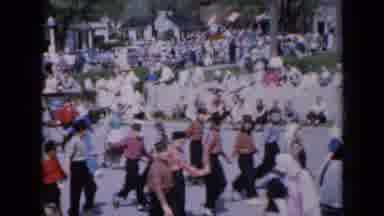 Iowa USA (1959): A Large Group Of Children Hold Hands And March The Streets As A