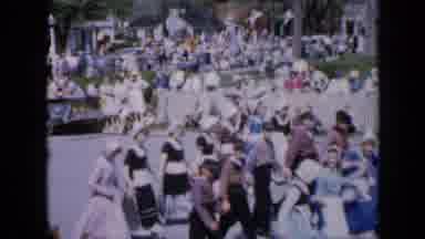 Iowa USA (1959): People Walking In A Parade In The City While Other People Stand