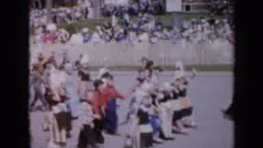 Iowa USA (1959): Parade Of Children Wearing Ethnic Costumes Waving To Onlookers As