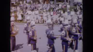 Iowa USA (1959): Marching Band In Festival Then Floats With People Dancing On Them