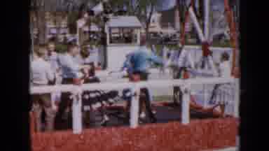 Iowa USA (1959): People Dancing On A Float In A Parade Riding Down The Street