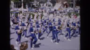 Iowa USA (1959): Marching Band Going Through The Streets In The Middle Of A Parade
