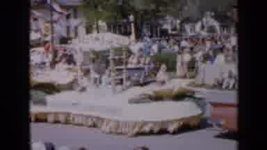 Iowa USA (1959): Big Float In A Parade With People Sitting And Waving On It