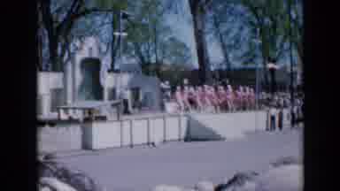 Iowa USA (1959): Dancers Skip Forward Then Rider Parades Down Street Carrying Flag