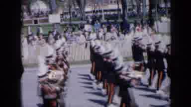 Iowa USA (1959): Marching Band Marching In An Event Or Festival As People Watch