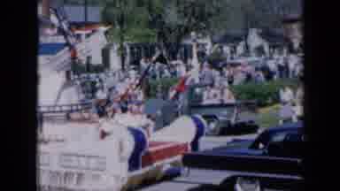 Iowa USA (1959): Parade With Floats Parading On National Holiday On A Sunny And
