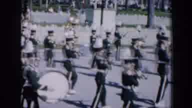 Iowa USA (1959): Marching Band And People On A Float In A Parade