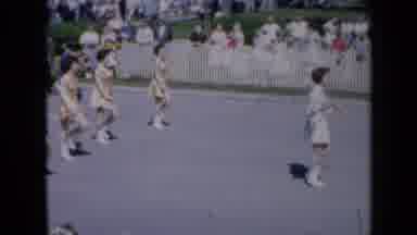 Iowa USA (1959): Marching Band And Dancers In A Parade Then Small Float Towards
