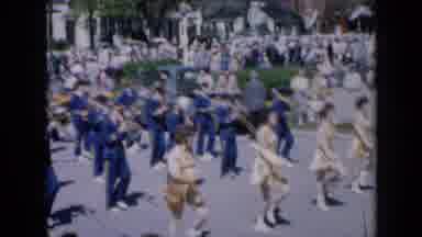 Iowa USA (1959): Baton Twirlers With A Marching Band Behind Them In A Parade