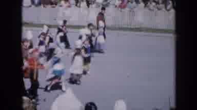 Iowa USA (1959): Marching Band And Costumed Children And Adults Walking In A