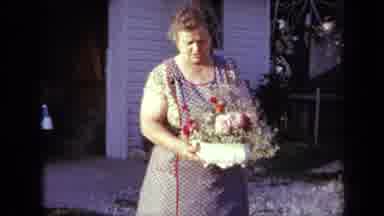 Iowa USA (1959): Woman In Apron Showing Flower Arrangement