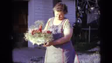 Iowa USA (1959): Older Lady Taking Care Of Her Flowers And Garden Outside Her Home