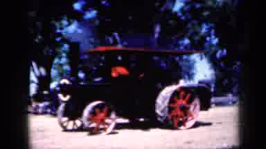 Iowa USA (1959): A Steam Powered Tractor Moves Slowly Across A Dirt Field Near A