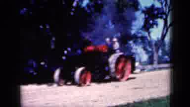 Iowa USA (1959): Steam Tractor Traveling Across A Dirt Field On A Sunny Day