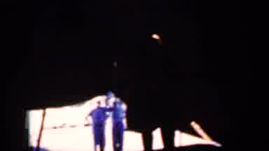 Iowa USA (1959): Couple Under A Tent With Two People Dressed In Blue In The Back