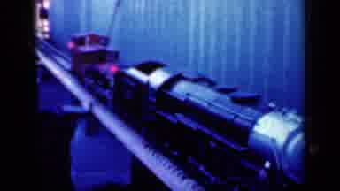 Iowa USA (1959): Red And Black Toy Train Going Down The Tracks Slow