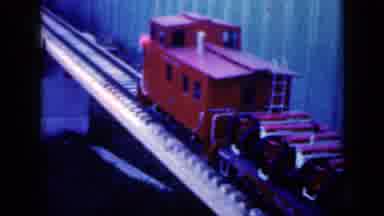 Iowa USA (1959): Model Train Moving Slowly Along Tracks Man Driving A Small