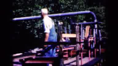 Iowa USA (1959): Men In Overalls Working On Machines With Steam And Conveyor Belts