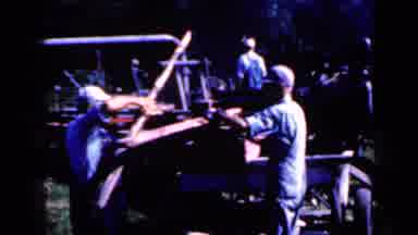 Iowa USA (1959): Elderly Gentleman Skipping While Unloading A Truck With Fence
