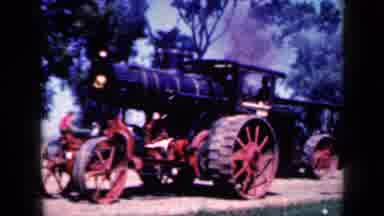 Iowa USA (1959): A Black Train Car On Red Tires Going Down The Road