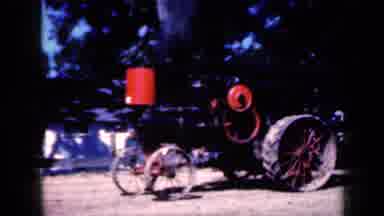 Iowa USA (1959): Two Old Tractors With Skinny Wheels Moving Slowly While Their