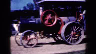 Iowa USA (1959): Old School Tractor Driving In Field On Farm On Summer Day