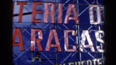 Venezuela (1959): View Of Sign That Reads Loteria De Caracas And A Person Sitting