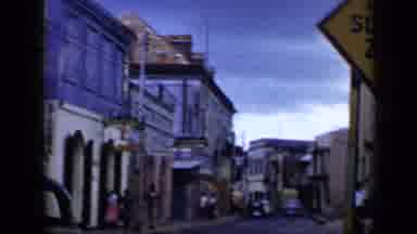 Venezuela (1959): Camera View Rapidly Arcs Around A Compact Asian Looking Street