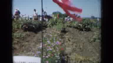 Missouri USA-1961: Flag Blowing In Wind At Flower Garden With Crowd