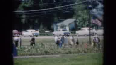 Missouri USA (1961): Cars Line Up To Park While Numerous People Walk Through