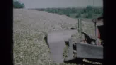Missouri USA-1961: Vintage Bulldozer Pushes Mulch in Rural Field