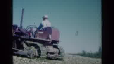 Missouri USA (1961): View Of Red Tractor And Large White Storage Building On A