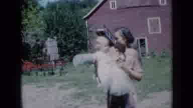 Missouri USA (1961): Grandmother Holding Baby On An Old Farm In The Yard In Front