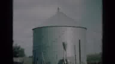 MISSOURI USA-1961: Aluminum Silo And Red Barn On A Rural Country Farm