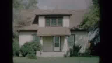 Missouri USA (1961): A Two-Story Home Surrounded By Trees And Shrubs Sits On A