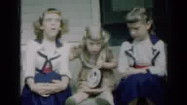 Missouri USA (1961): A Little Girl Plays A Toy Instrument While Two Older Girls