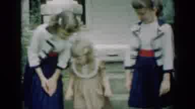 Missouri USA (1961): Two Young Girls Wearing Matching Dresses Standing With A